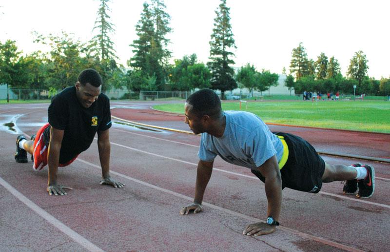 A member of ROTC teaches a basketball player how to do a proper pushup on the wet track at Warmerdam Field.
Photos courtesy of Arturo Ramirez
