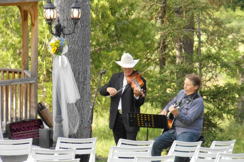 Tim Johnson plays the violin at a wedding with colleague Rich Severson. Johnson plays at churches, schools, weddings and rodeos. Johnson is a member of The Sierra Riders Band who release their second album in December.
Photo courtesy of Tim Johnson