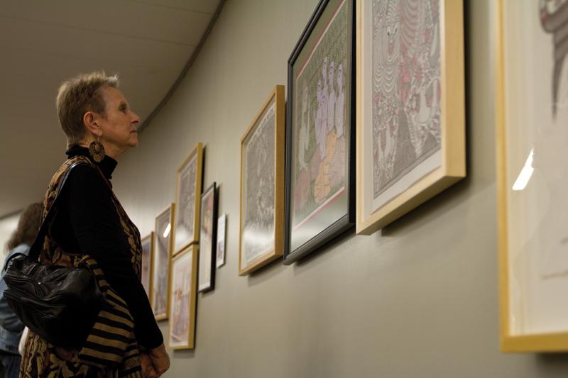 Community members look closely at the details in the Mithila paintings that were brought to campus from the Madhubani District in India. Joan Sharma, professor of art and design, presented the exhibition.
Roe Borunda / The Collegian