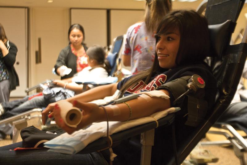 During the blood drive kick-off in the Resident Dining Hall located on campus, sophomore kinesiology major Stephanie Gomez donates blood for the second time. Gomez was influenced by her sister’s willingness to give blood, she said. 
Roe Borunda/ The Collegian