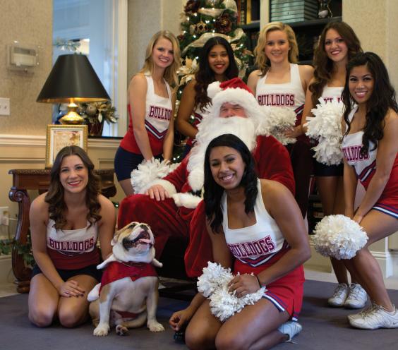 ONE LUCKY ’DOG: The Fresno State Dance and Cheer team along with Victor E. II visit Santa in the Smittcamp Alumni House Library on Dec. 7. Fresno State welcomed alumni, students and friends to take photos and enjoy holiday cookies. 