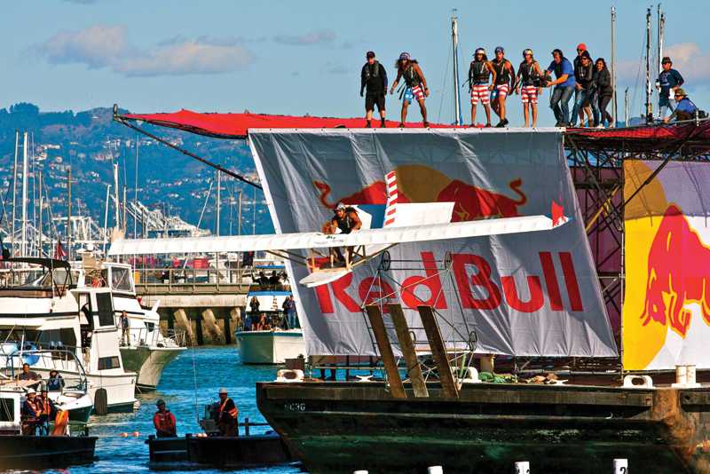 Californaut+team+member+Raffy+Sencion+glides+toward+the+water+while+piloting+La+Flama+Blanca%2C+a+winged+25-foot-long+surfboard-themed+craft+built+to+compete+during+the+2012+Red+Bull+Flugtag+at+McCovey+Cove+in+San+Francisco%2C+while+the+rest+of+the+team+watches+from+the+30-foot+ramp.+The+team+took+seventh+place+out+of+36+competitors%2C+and+managed+to+win+the+Peoples+Choice+award.+%0D%0APhotos+courtesy+of+Tim+Anderson