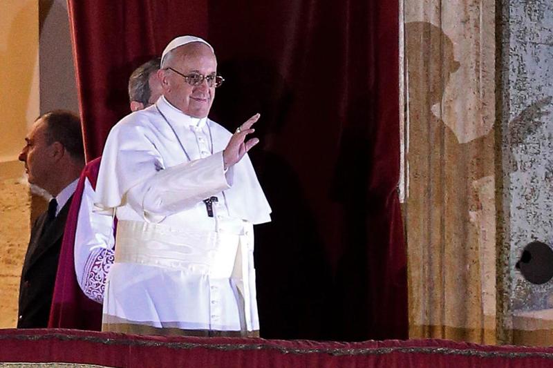 Pope Francis stands on the balcony of Saint Peter’s Basilica in Vatican City waving to the thousands gathered in Saint Peter’s Square. The first non-European pope, he was elected by the College of Cardinals on Wednesday evening. 
McClatchy-Tribune