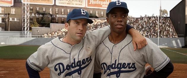 42 stars Chadwick Boseman (right) as Jackie Robinson. Courtesy of Warner Bros