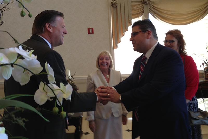 Former athletic director Thomas Boeh shakes hands with Fresno State President Joseph Castro.