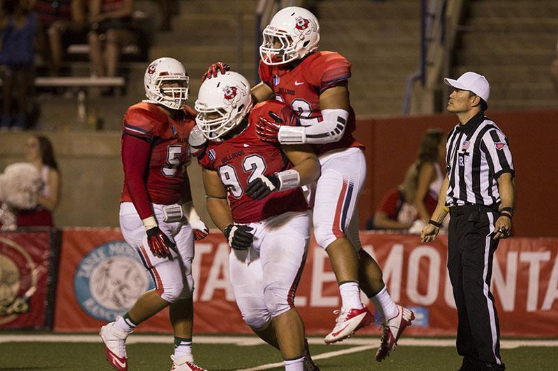 Fresno State defensive lineman Tyeler Davison celebrates with his teammates after the Bulldogs defense made a defensive stop against Cal Poly Saturday night at Bulldog Stadium.  
