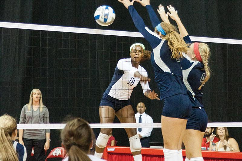 Outside hitter Zana Bowens rockets a ball past Rice defenders during the Bulldogs’ five-set victory over the Rice Owls in the first game of the Bulldog Invitational. Photo by Khlarissa Agee/The Collegian