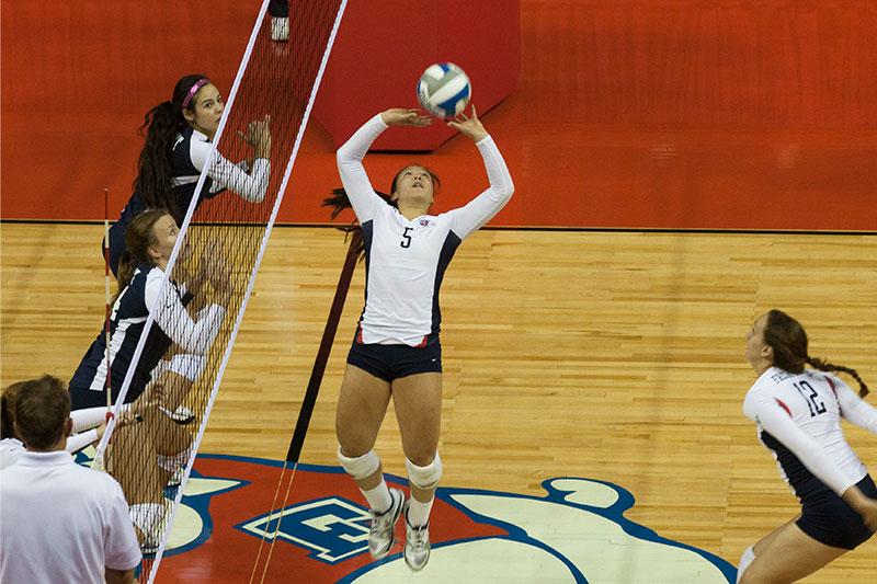 Junior Christina Lee sets a ball up for middle blocker Molly Pearson as the Bulldogs face the Belmont Bruins in the first game of the Fresno State Classic. Photo by Khlarissa Agee/The Collegian