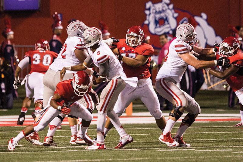 Fresno State outside linebacker Ejiro Ederaine (31) forces UNLV quarterback Caleb Herring (8) into a quick throw in the Bulldogs’ 38-14 win over the Rebels Saturday at Bulldog Stadium.