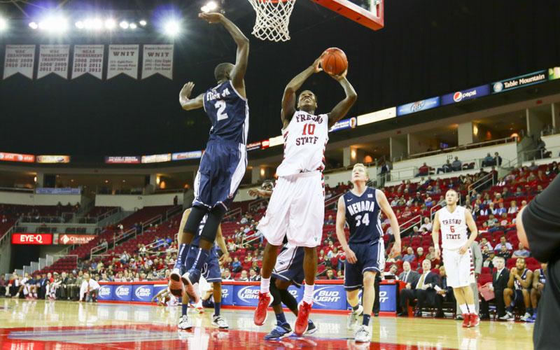 Fresno States Alex Davis battles Nevadas Jerry Evans, Jr., on the way to the basket in the Bulldogs 96-86 double-overtime loss to the Wolf Pack Wednesday night. (Photo by Katie Eleneke/The Collegian)