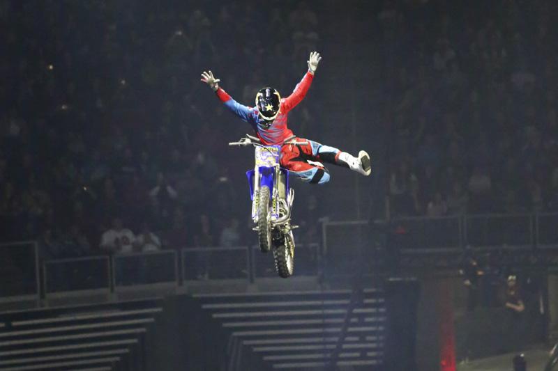 A freestyle motocross rider performs a trick during Nitro Circus Live