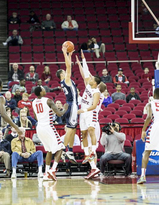 Two Fresno State Bulldogs attempt to block a shot attempt by Nevadas Michael Perez during the Bulldogs 96-86 double-overtime loss to Nevada. (Photo by Katie Eleneke/The Collegian)