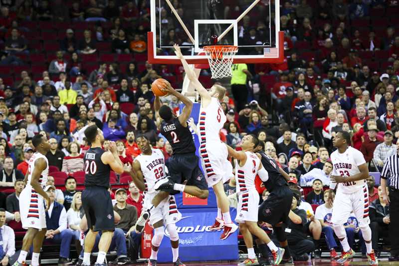 Fresno State center Tanner Giddings jumps up to block a shot attempt by San Diego State’s Xavier Thames during the Bulldogs’ 82-67 loss last Saturday. Photo by Katie Eleneke/The Collegian