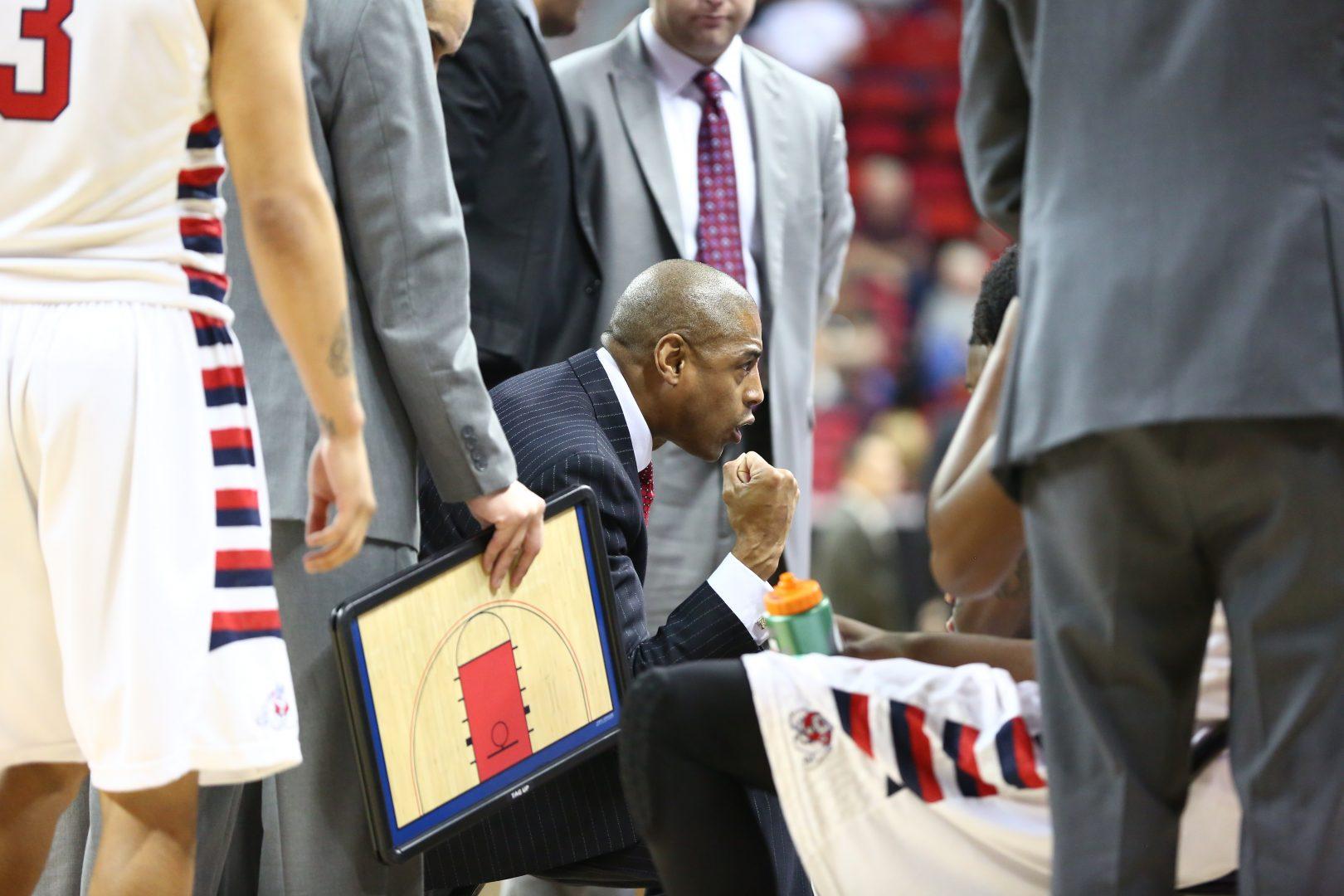 Fresno State head coach Rodney Terry instructs his team during a timeout in the Bulldogs 61-59 victory over Air Force Wednesday night. Photo by Khlarissa Agee/The Collegian