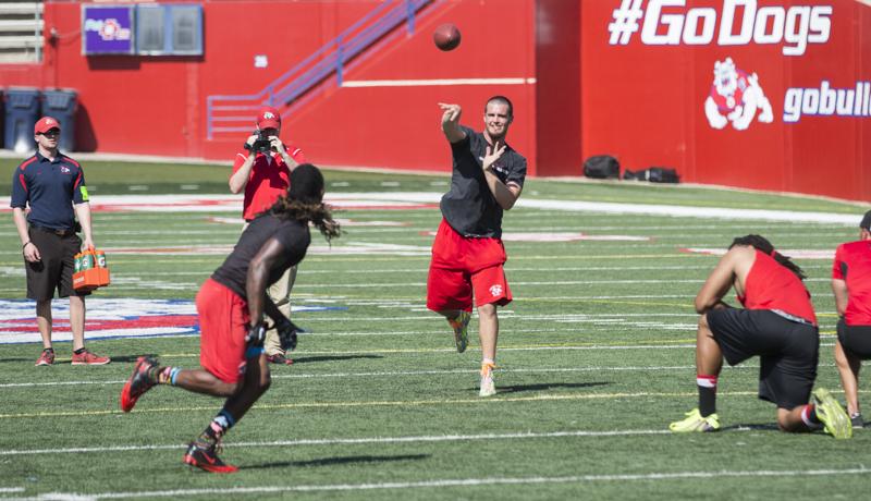 Fresno State alum Derek Carr passes the ball to Isaiah Burse during one of the drills at Pro Day. Photo by Matt Vieira/The Collegian