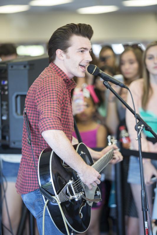 Julian Paredes / The Collegian
Drake Bell sings to the crowd gathered at f.y.e. in Clovis Wednesday afternoon. 
Bells new album, Ready, Steady, Go! was released on Tuesday  featuring new music genres from Bell.