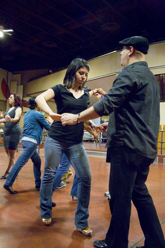 Pete Swingle, salsa instructor and participant Raquel Araya practice during the salsa lessons of  “Blast to the Past.”