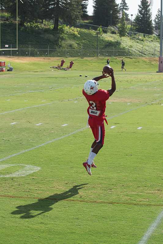 Fresno State wide receiver Josh Harper leaps for a pass during Fresno State's fall camp practice last Tuesday. Harper will lead the 'Dogs' wide receivers into the season as one of the team's two captains. Photo by Darlene Wendels/The Collegian