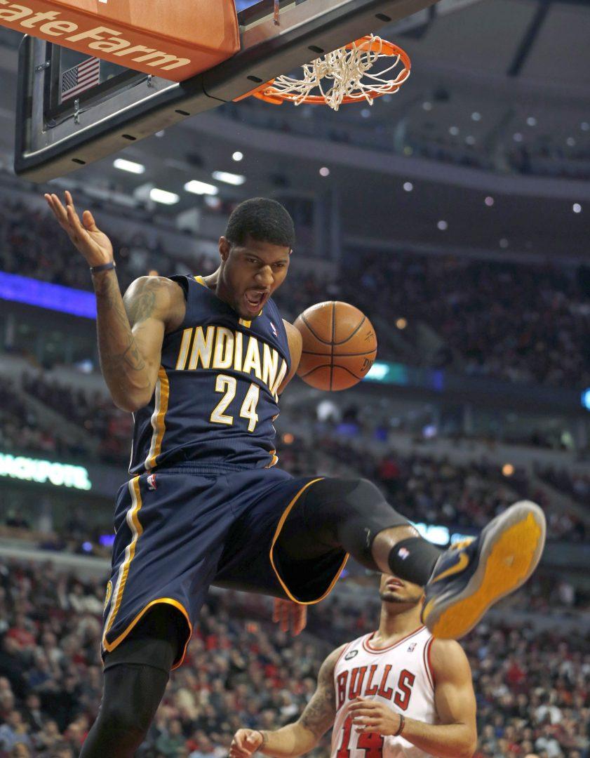 Indiana Pacers Paul George reacts to dunking against Chicago Bulls DJ Augustin in the 1st quarter on Monday, March 24, 2014, in Chicago. George played two seasons at Fresno State before being drafted by the Pacers in 2010. Photo by Scott Strazzante/Chicago Tribune/MCT