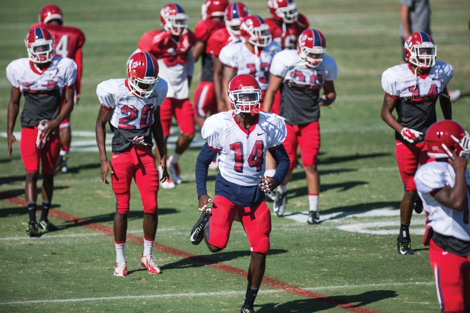 Fresno State safety Justin Holmes (14) and the Bulldogs gear up for afternoon practice Monday at the field west of Bulldog Stadium. The team will visit New Mexico Friday for its first conference matchup. Photo by Darlene Wendels/The Collegian