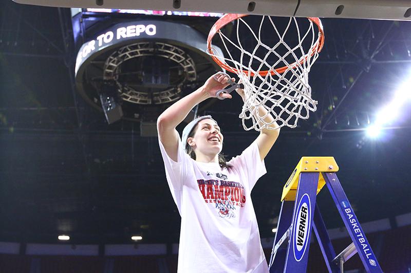 Fresno State alumna Bree Farley cuts a portion of the net during the Bulldogs’ Mountain West Championship celebration in Las Vegas last March. Farley signed a contract to play for GDESSA Barriero in Portugal. Photo by Khlarissa Agee/The Collegian