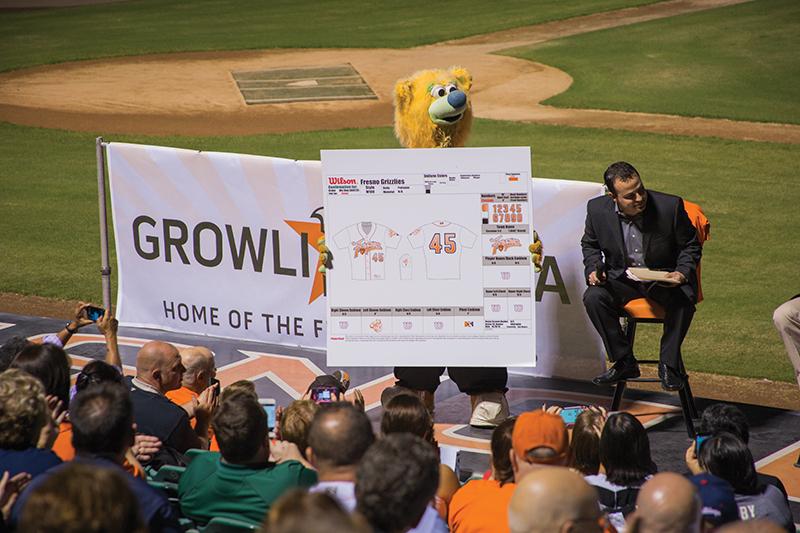 Fresno Grizzlies mascot Parker the Bear holds up a board featuring the team’s new uniform and logo designs during the meet-and-greet at Chukchansi Park Thursday. Photo by Darlene Wendels/The Collegian
