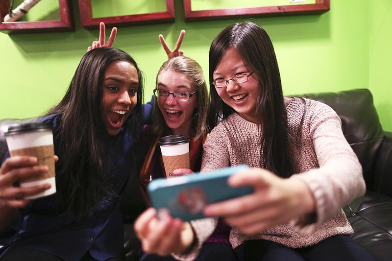 Friends Amrita Mohanty, 16, from left, Marta Williams, 16, and Michelle Mao, 15, take a Snapchat "selfie" while having coffee at the Steepery Tea Bar in Woodbury, Minn., Dec. 12, 2013. (Renee Jones Schneider/Minneapolis Star Tribune/MCT)