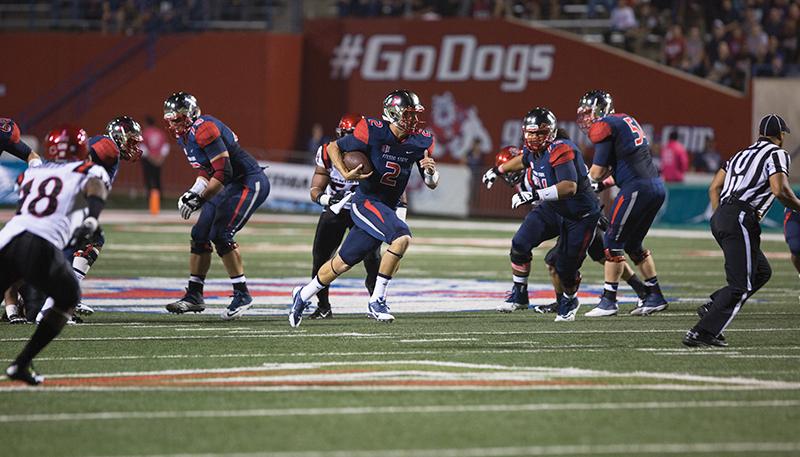 Fresno State quarterback Brian Burrell (2) keeps the ball and runs for positive yards against the San Diego State Aztecs during the ‘Dogs’ 24-13 win last Friday at Bulldog Stadium. Burrell will start against the UNLV Rebels today at Sam Boyd Stadium in Las Vegas. Photo by Darlene Wendels/The Collegian