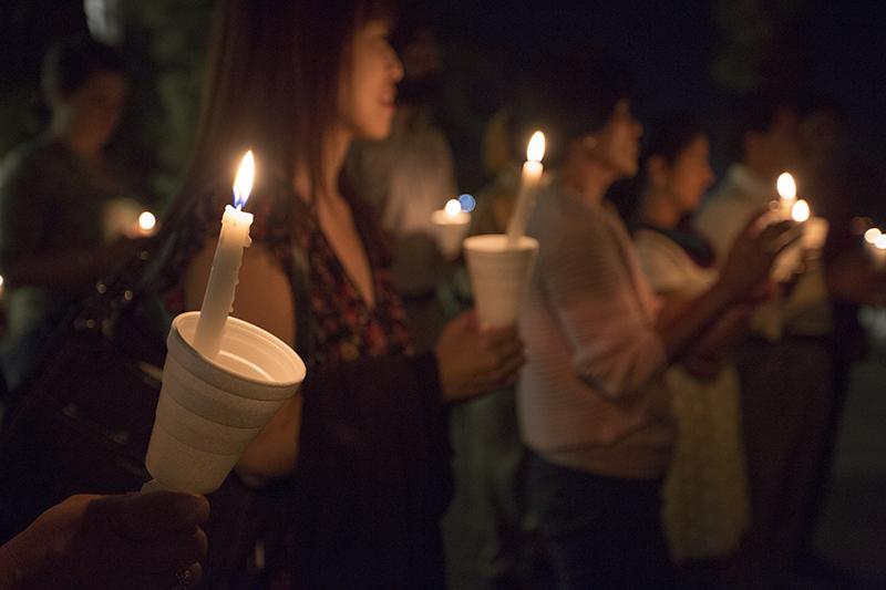 A crowd of about 60 gathered for a candlelit vigil Thursday night in the Peace Garden to celebrate Gandhis birthday. Darlene Wendels / The Collegian