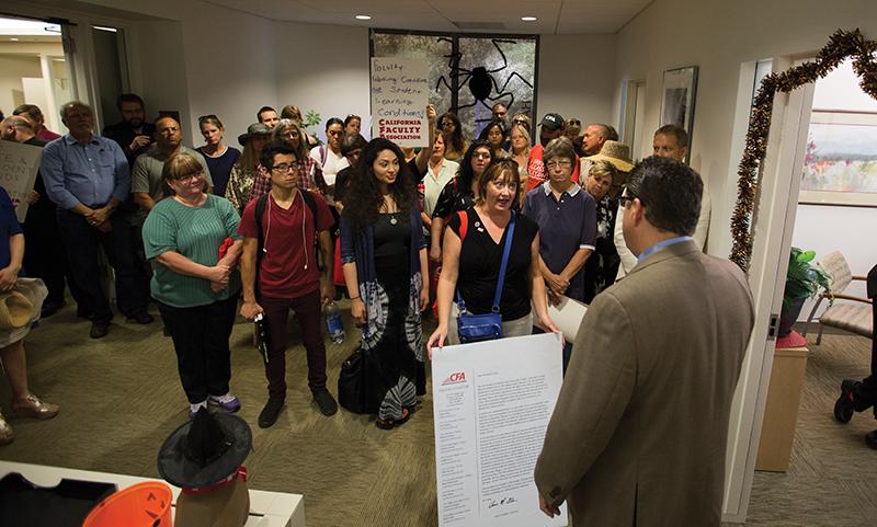 A delegation of faculty members and students deliver a letter to Fresno State President Joseph Castro asking him to be bold in talks with the CSU administration for a new collective bargaining agreement. Darlene Wendels/ The Collegian 