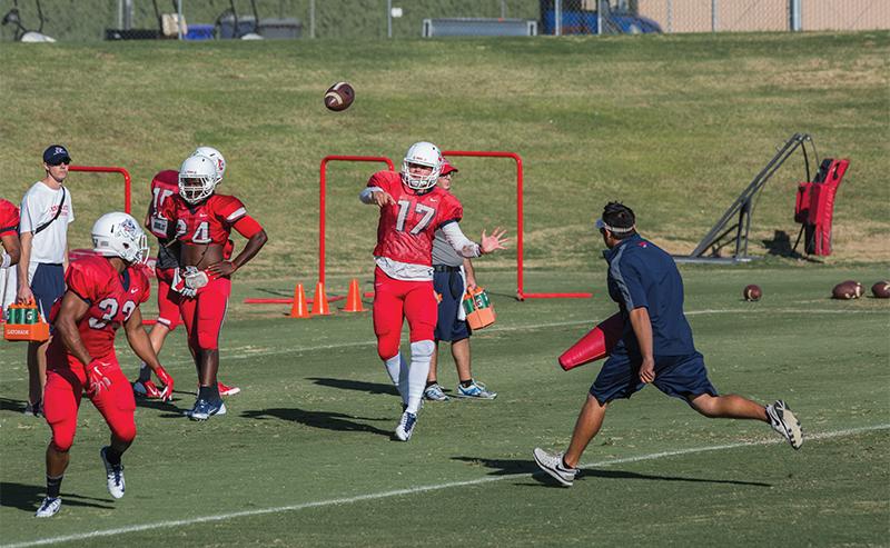 Fresno State redshirt freshman quarterback Zack Greenlee lobs a pass to running back Marteze Waller during the Bulldogs’ practice Tuesday. Greenlee will make his first start Saturday when the ‘Dogs host Wyoming. Photo by Darlene Wendels/The Collegian