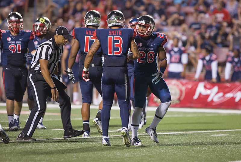 Fresno State defensive backs Derron Smith (13) and Charles Washington (28) meet during the Bulldogs’ 24-13 win over the San Diego State Aztecs at Bulldog Stadium Oct. 3. Both Smith and Washington plan on improving Fresno State’s turnover margin Friday in Boise, Idaho. Photo by Darlene Wendels/The Collegian