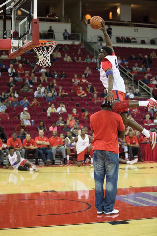 Fresno State sophomore forward Karachi Edo dunks over former Bulldog Shannon Swillis during the dunk contest at the Red and White Hoops Night Tuesday at Save Mart Center. Photo by Logan Downing/The Collegian