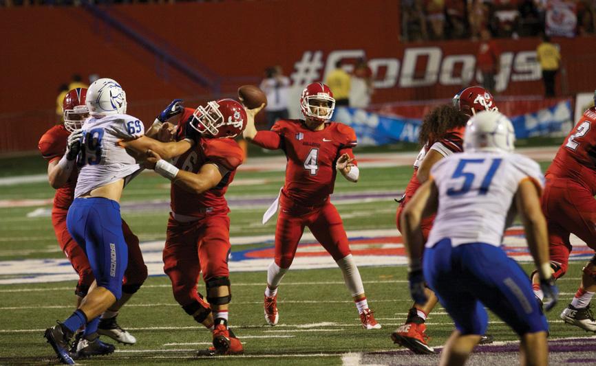 Former Fresno State quarterback Derek Carr (4) attempts a pass during the Bulldogs’ 41-40 victory over the Boise State Broncos at Bulldog Stadium on Sept. 20, 2013.  Photo by Roe Borunda/The Collegian
