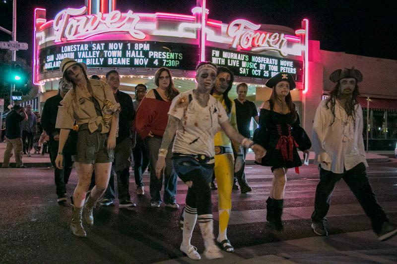 Logan Downing / The Collegian
Participants of the annual Zombie Pub Crawl showcase their various zombie outfits in the Tower District on Saturday.
