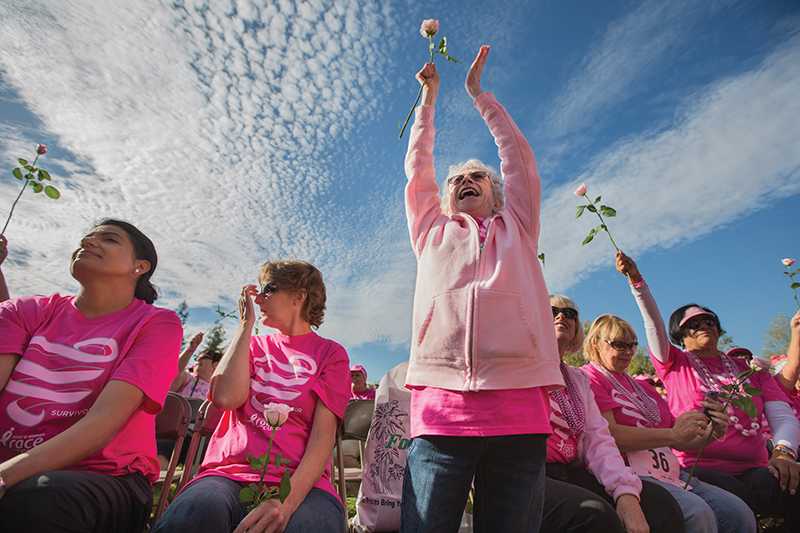 Mary Ann Bellissima, a survivor of cancer, waves her rose during the survivor recognition ceremony at the 2014 Komen Central Valley Race for the Cure on Saturday, Oct. 25. Darlene Wendels / The Collegian 