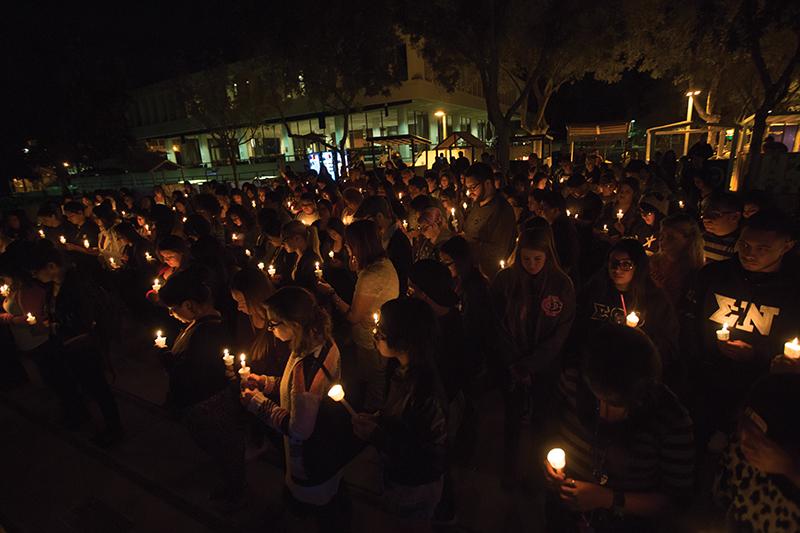 People gather in Fresno States Free Speech Area during for a candlelight vigil during Take Back The Night Wednesday. Darlene Wendles/ The Collegian.  