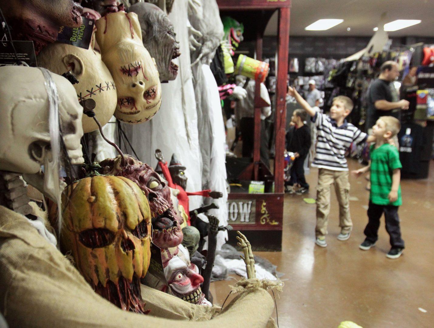 Connor Bartholomew, 8, and his brother, Miles, 5, right, enjoy holiday-themed displays at Spirit Halloween in Biloxi, Mississippi, on Wednesday, October 23, 2013. (John Fitzhugh/Biloxi Sun Herald/MCT)
