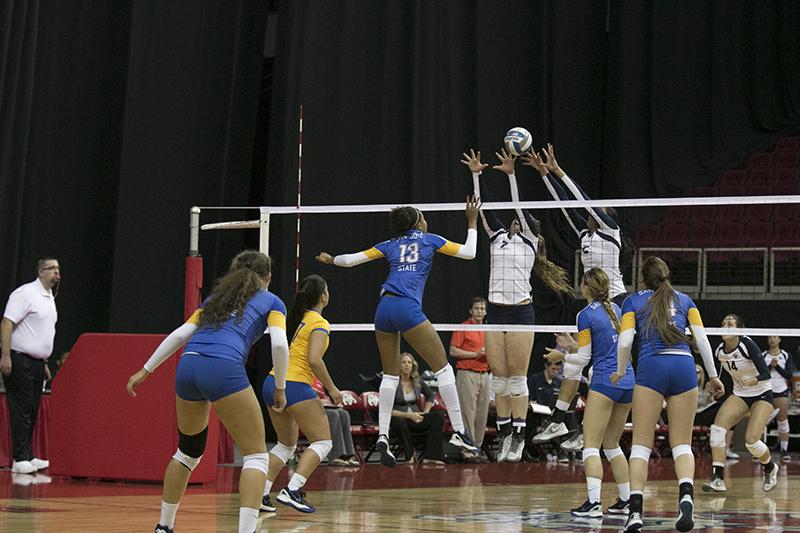 Fresno State freshmen Carly Scarbrough and Lauren Torres attempt to block a San Jose State spike during the Bulldogs’ 3-0 sweep of the Spartans Saturday at the Save Mart Center. Photo by Logan Downing/The Collegian