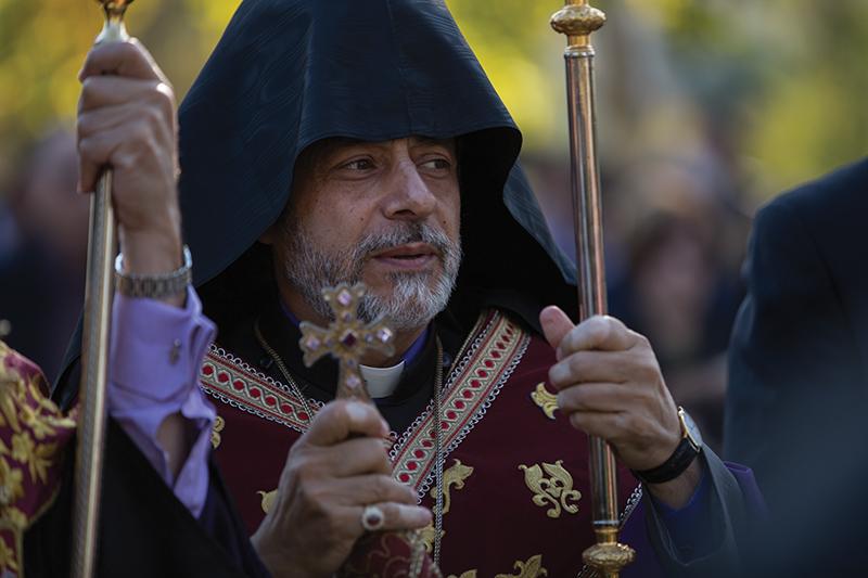 Archbishop Hovnan Derderian, Primate of the Western Diocese, prepares to bless the soil that will be placed at the groundbreaking point of the Armenina Genocide Monument. Darlene Wendels / The Collegian