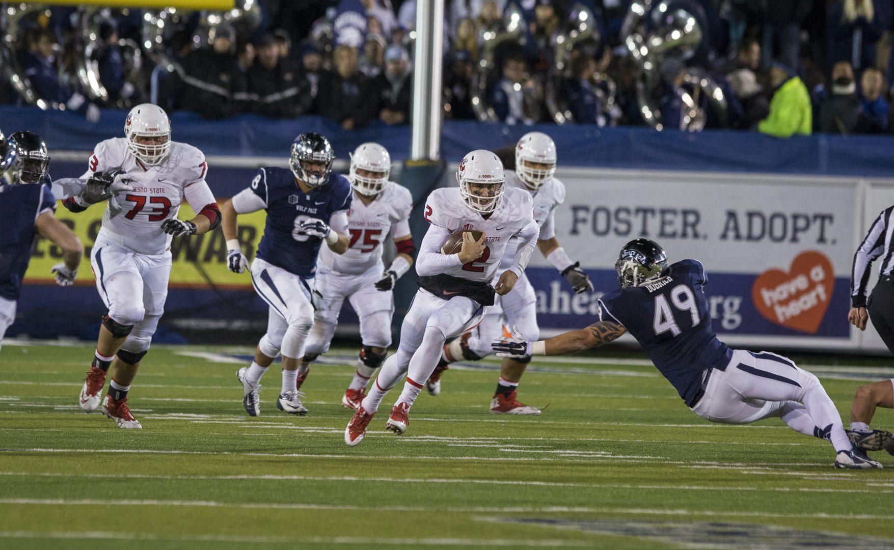 Fresno State quarterback Brian Burrell (2) rushes past the Nevada Wolf Pack defense during the Bulldogs 40-20 victory Saturday night at Mackay Stadium in Reno, Nevada. Photo by Darlene Wendels/The Collegian