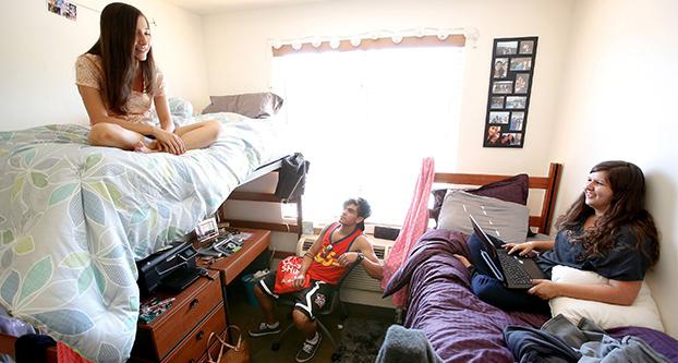 Shelby Ryan, 18, left, from Sherman Oaks, a freshman at Cal State Northridge, and her roommate Abby Souza, 18, right, from Davis, hang out inside their dorm room with Austin Garcia, 18, from Bakersfield, who was visiting from his room located down the hall of the coed dorm, August 26, 2013. All three students are freshmen. (Mel Melcon ”¢ Los Angeles Times/TNS)