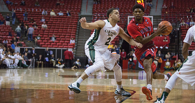Fresno State guard Julien Lewis (right) takes the ball inside the paint against defending Colorado State guard Daniel Bejarano during the ‘Dogs’ 71-59 loss to the Rams in the quarterfinals of the Mountain West Tournament on Thursday. (Darlene Wendels/The Collegian)