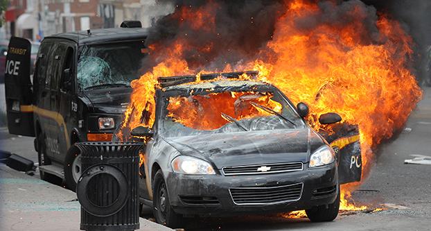 A Maryland Transit Authority patrol car burns at North and Pennsylvania avenues on Monday, April 27, 2015, in Baltimore. (Jerry Jackson ”¢ Baltimore Sun/TNS)