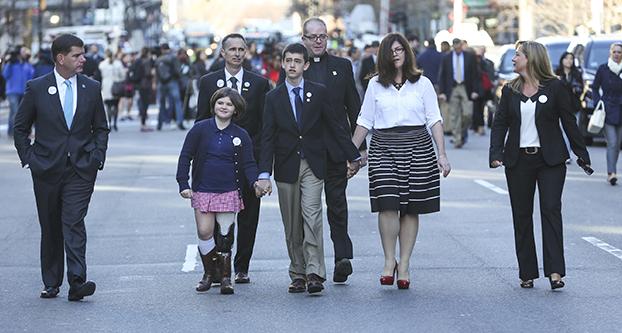 Boston Mayor Marty Walsh, left, joins members of the Richard family as they walk down Boylston Street in Boston on Wednesday, April 15, 2015. The Richard family lost 8-year-old Martin in the bombing. (Nicolaus Czarnecki ”¢ Boston Herald/TNS)