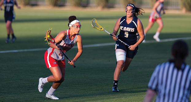 Fresno State junior Ariel Ross evades UC Davis’ Melissa Kellan during the ‘Dogs’ 11-6 loss to the Aggies Wednesday at the Soccer and Lacrosse Field (Paul Schlesinger/The Collegian)