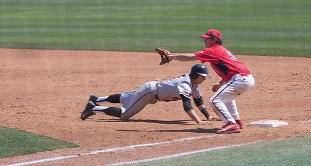Fresno State first baseman Kevin Viers (right) attempts to tag out a San Diego State base runner during Sundays 9-4 loss to the Aztecs. (Darlene Wendels/The Collegian)