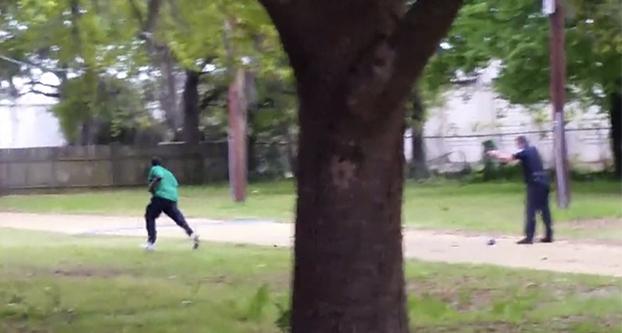 In a video taken by Feidin Santana, a bystander, this is the moment Officer Michael Slager (right) began to shoot eight rounds at the back of Walter Scott who was unarmed as he fled. Scott died shortly afterward.