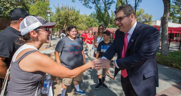 Fresno State President Joseph Castro greets parents of the incoming students moving into the student dorms, Friday, Aug. 21, 2015. (Darlene Wendels/The Collegian)