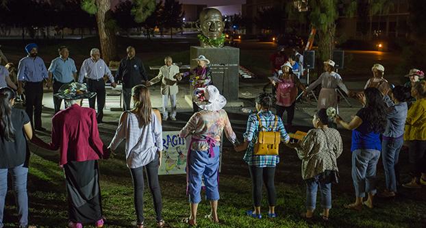 Fresno+State+students%2C+faculty%2C+and+community+members+gather+in+front+of+the+Mahatma+Gandhi+memorial+statue+in+the+Peace+Garden+during+a+candlelight+vigil+in+celebration+of+Gandhi%E2%80%99s+146th+birthday%2C+Friday%2C+Oct.+2%2C+2015